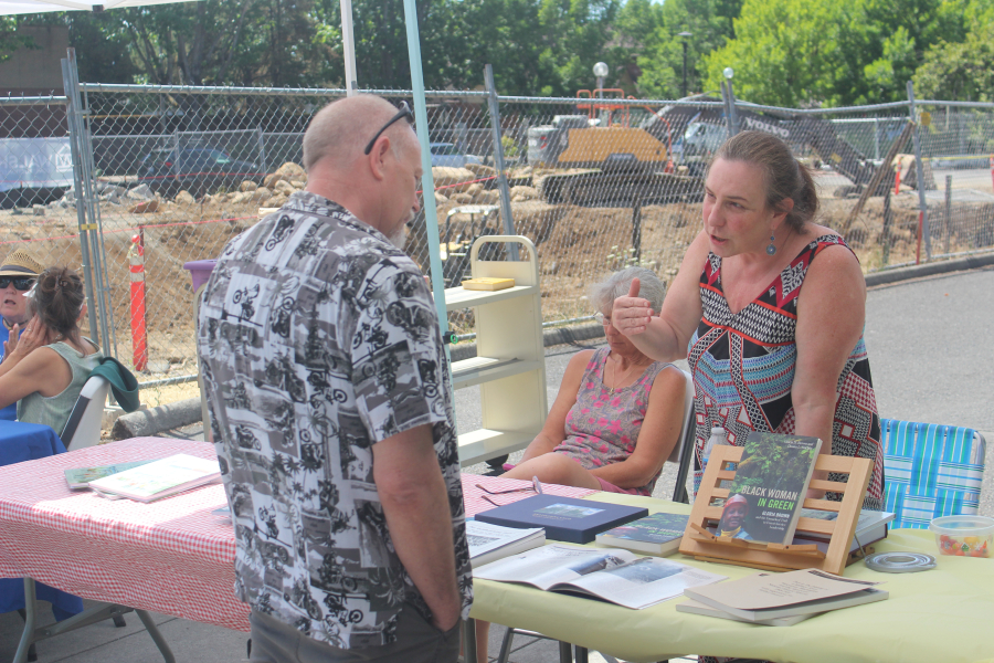 Washougal resident Donna Sinclair (right) talks to an attendee about her book, 