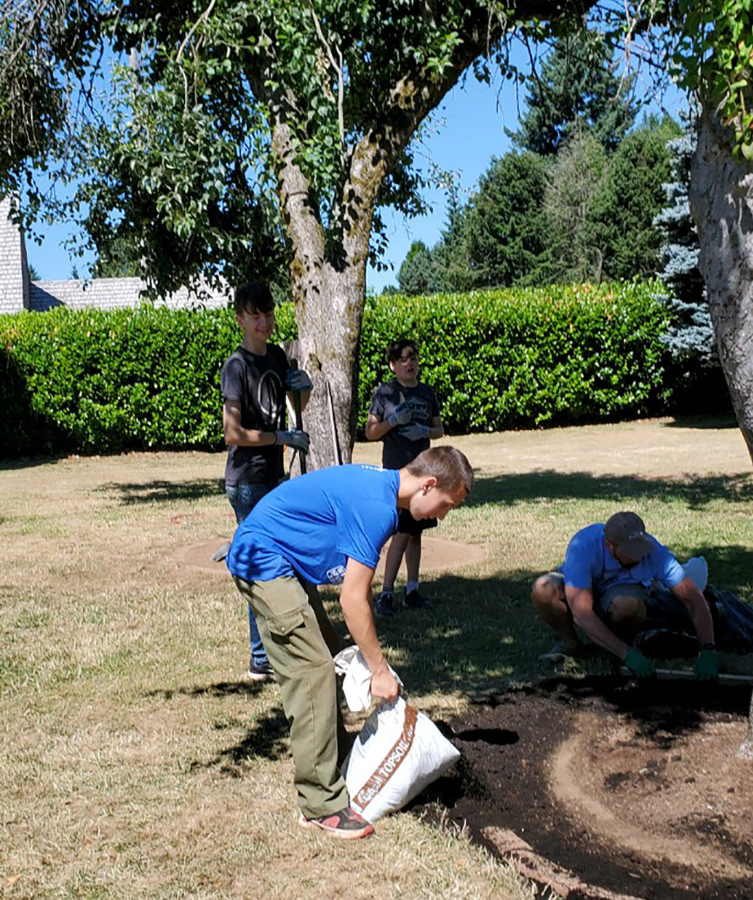  (Contributed photo courtesy of Susan Tripp
Camas High School senior Harris Royer, 17, places bark around a tree at Parkersville Landing in July 2023.)