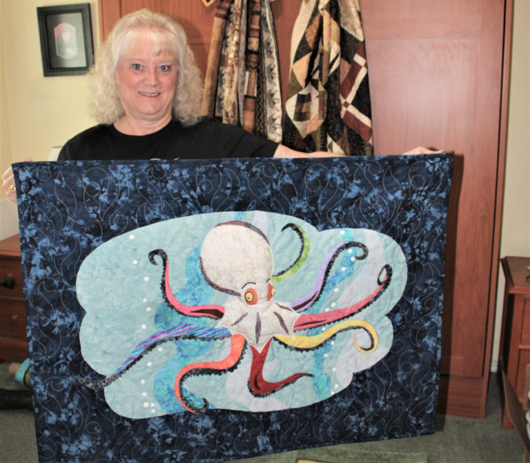 East Clark County artist Deborah Watson shows one of her 3-D art quilts featuring an octopus from her home on Thursday, Aug. 17, 2023.