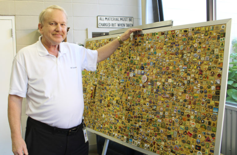 Ron Hawkins, curators of the Camas paper mill's interpretive center, stands next to his collection of historical buttons Friday, Sept. 1, 2023, during a celebration of the mill's 140th anniversary.
