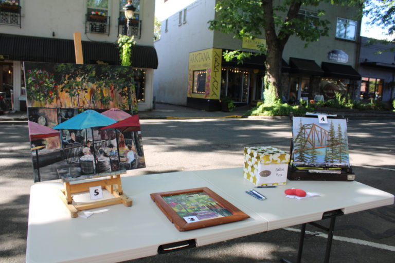 Completed "plein air" paintings sit outside the Camas Gallery in downtown Camas Friday, Sept. 1, 2023.