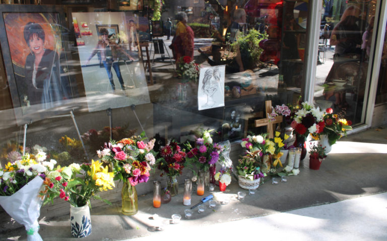 Flowers and candles honoring Camas Gallery owner Marquita Call fill the sidewalk in front of the downtown gallery Friday, Sept. 1, 2023, three days after Call's unexpected death on Aug. 28, 2023.