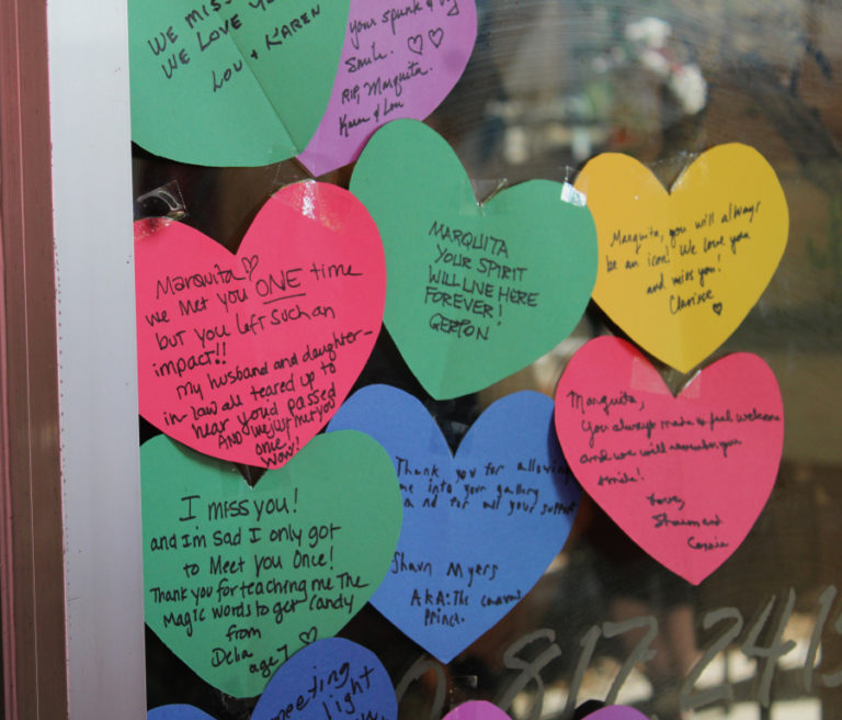 Paper hearts with handwritten messages remembering Camas Gallery owner Marquita Call line the front window of the downtown gallery Friday, Sept. 1, 2023, three days after Call's unexpected death on Aug. 28, 2023.