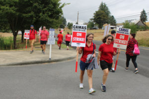 Members of the Camas Education Association, the union representing roughly 450 public school teachers in the Camas School District, walk the picket line in front of Camas High School Monday, Aug. 28, 2023. The Camas School District and its teachers' union reached a tentative contract Wednesday, Sept. 6. Camas students are set to return to the classroom for the start of the 2023-24 school year on Friday, Sept. 8. (Kelly Moyer/Post-Record)