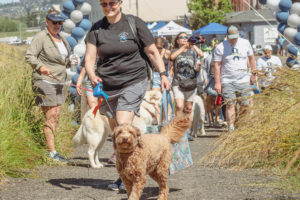 Washougal Police Chief Wendi Steinbronn walks her dog during the West Columbia Gorge Humane Society's Hike on the Dike fundraising event in June 2022. (Contributed photo courtesy Peggy DiPrima)