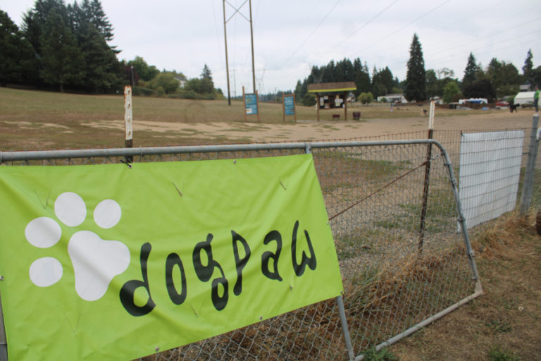 A DOGPAW sign adorns a fence outside the nonprofit group's IKE Memorial Dog Park in Vancouver, Saturday, Sept.