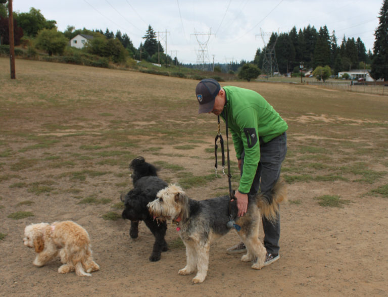 Scott Long, of Vancouver, greets his dogs, 9-year-old Beni (center) and 6-year-old Darby (right) on Saturday, Sept.