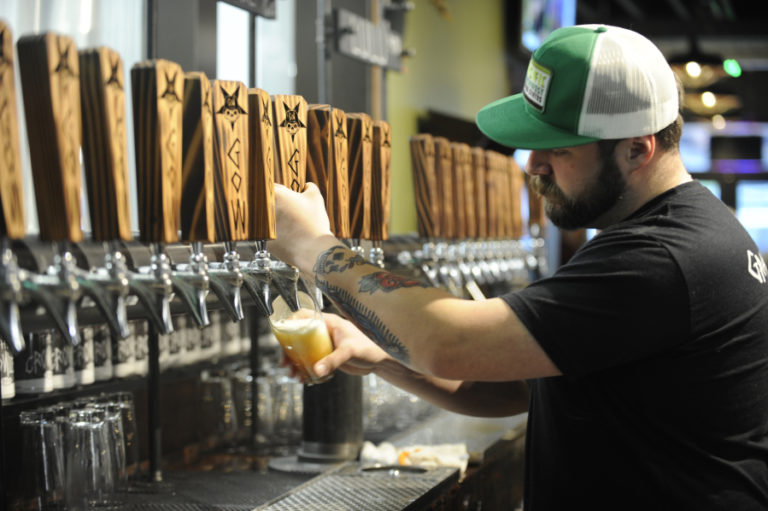 Post-Record file photo 
 Grains of Wrath bartender Adam Young pours one of the Camas brewery's house beers on Thursday, March 8, 2018.