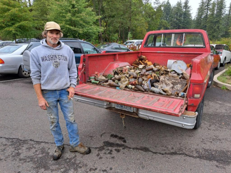 Kevin Melton, of Camas, shows a truckload full of glass and other debris he pulled from Lacamas Lake in Camas ahead of the annual lake cleanup event held Saturday, Sept. 30, 2023.