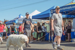 Attendees walk their dog during the annual Hike on the Dike fundraising event in Washougal June 25, 2022. The city of Washougal is considering changes to its dog permits in an effort to 