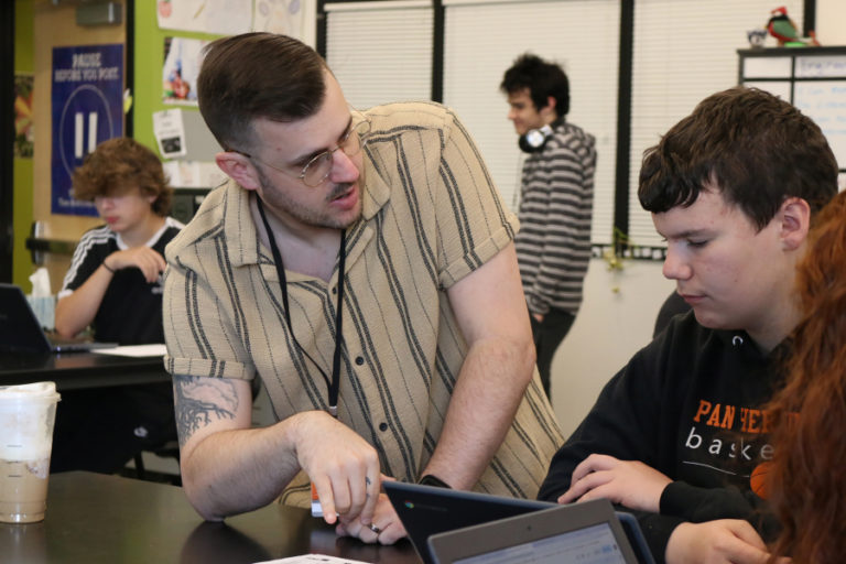 Kyle Rogers (left), an internship program director for Vancouver-based LSW Architects, reviews a parking lot design proposal with a Washougal High student in 2023.