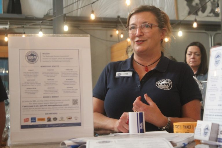 Doug Flanagan/Post-Record 
 Washougal Business Association board member Lori Reed talks during an open house event on Thursday, Oct. 12, at 54-40 Brewing Company in Washougal.