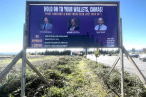 Drivers pass by an anonymous campaign sign targeting three Camas officials near the Southeast 192nd Avenue and Southeast Brady Road intersection on  Saturday, Oct. 28, 2023. (Kelly Moyer/Post-Record)