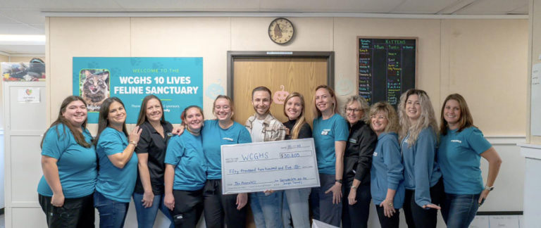 Contributed photo courtesy Weste Columbia Gorge Humane Society 
 Washougal residents Jake (sixth from left) and Kelsey (sixth from right) pose for a photograph with West Columbia Gorge Humane Society employees earlier this month. (Contributed photo courtesy Jake Straus)