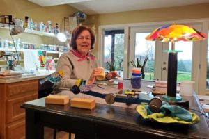 Fused glass artist Phyllis Carter works on a project at her home studio in Washougal in November 2023. (Contributed photo courtesy of Phyllis Carter)