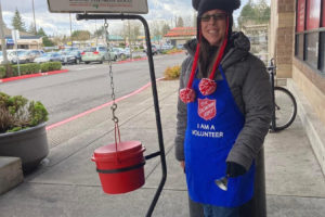 Contributed photo courtesy Camas-Washougal Salvation Army 
 Salvation Army of 
 Camas-Washougal volunteer Mychele Crase rings a bell in front of the Safeway store in Washougal in December 2022