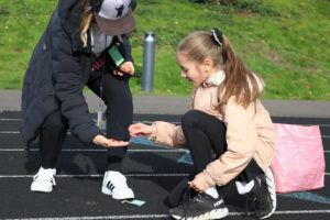 Contributed photo courtesy Washougal School District 
 Columbia River Gorge Elementary School fifth-grader Joela Grundy collects a token as a reward for finishing a lap during a Boosters Mileage Club session at the Jemtegaard Middle School track earlier this year. (Contributed photo courtesy of the Washougal School District)