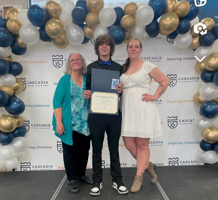 2023 Washougal High graduate Jacob Crawford (center) accepts a Cascadia Tech scholarship alongside his grandmother, Kelly Gutman (left), and his mother, Ashlee Crawford, in June 2023.
