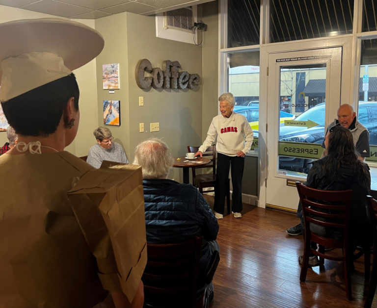Camas historian Virginia Warren  (center) talks about growing up in Camas in Caffe Piccolo in downtown Camas Friday, April 7, 2023, during the Downtown Camas Association’s “Spring into History” First Friday event.