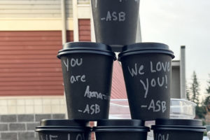 Washougal High School leadership students show off the hot chocolate cups, decorated with personalized thank-you messages, before giving them to bus drivers Nov. 21, 2023. (Photo courtesy of the Washougal School District)