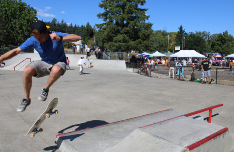 A skateboarder performs tricks at the newly remodeled Riverside Bowl Skatepark in Camas as crowds gather in the background for the park's grand reopening celebration on Thursday, July 27, 2023.