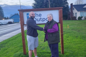 Don Stoner (left), the owner and lead instructor of the Lone Wolf Jiu Jitsu Academy, and The Outpost's Pam Young stand outside The Outpost in Washougal, in December 2023. (Contributed photo courtesy of Don Stoner)