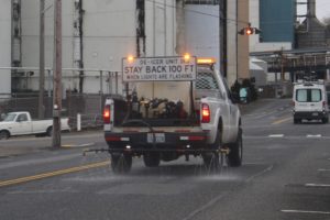 A city of Camas de-icing vehicle sprays de-icer along Northeast Sixth Avenue in downtown Camas, Friday, Jan. 12, 2024, ahead of a winter storm expected to drop 2 to 4 inches of snow on the greater Vancouver area Saturday, Jan. 13, 2024. (Kelly Moyer/Post-Record) 