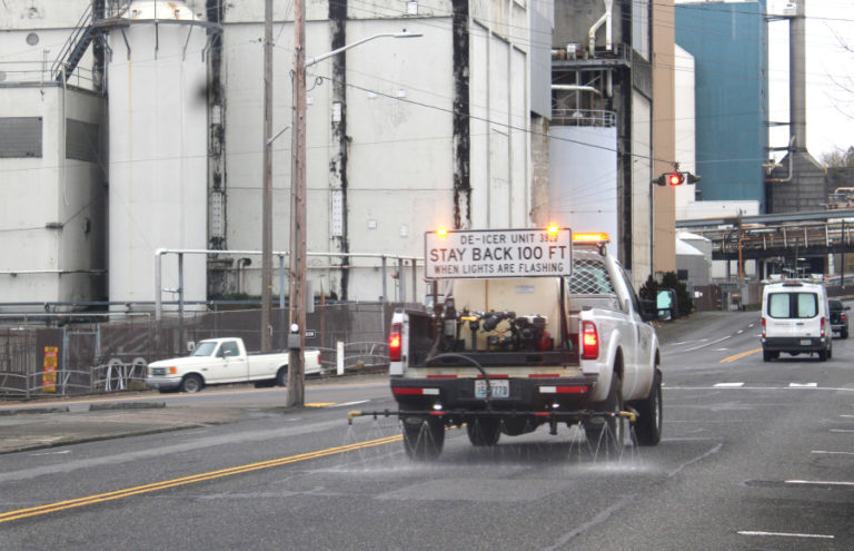 A city of Camas vehicle sprays deicing fluid on Northeast Sixth Avenue in downtown Camas, ahead of a winter storm, Friday, Jan. 12, 2024.