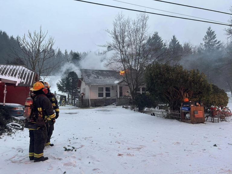 Firefighters battle a wind-driven structure fire off Southeast Blair Road north of Camas-Washougal, Saturday, Jan. 13, 2024.