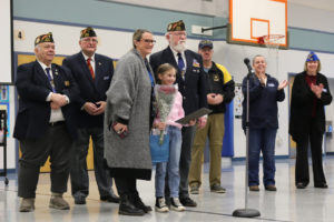 Veterans of Foreign Wars Post 4278 honors Scout Eldridge (fourth from left), a student at Gause Elementary School in Washougal, as a winner of the statewide Junior Essay Contest in January 2024. (Contributed photo courtesy of the Washougal School District)