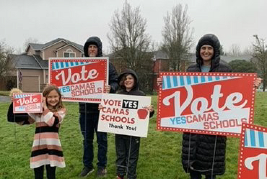 Supporters of the Camas School District replacement levies wave pro-levy signs in Camas ahead of the Feb. 13, 2024 Special Election. (Contributed photo courtesy of Concerned Citizens for Quality Schools)