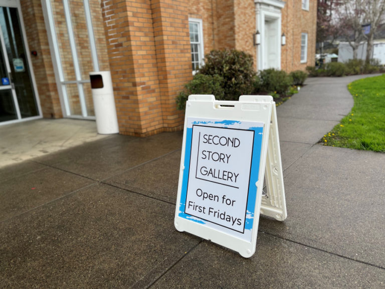 A sign points visitors to the Second Story Gallery inside the Camas Public Library Friday, April 7, 2023.