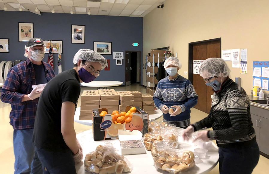 ReFuel Washougal volunteers prepare meals for their Friday night guests at the Washougal Community Center in an undated photo. (Contributed photo courtesy of Fran Whitmeyer)