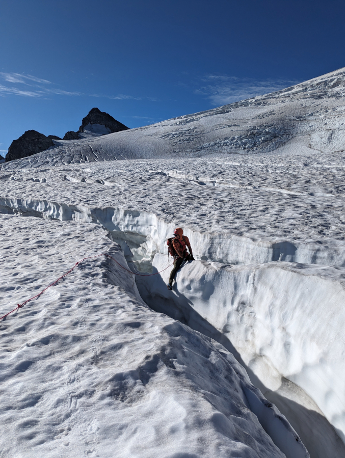 Andrew Okerlund crosses the Neve Glacier on Snowfield Peak with his brother, Vaughn Okerlund, during the summer of 2023.