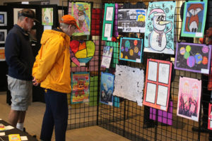 Attendees look at student artwork during the 2022 Washougal Youth Arts Month gallery exhibit at Washougal High School, March 23, 2022. (Doug Flanagan/Post-Record files)