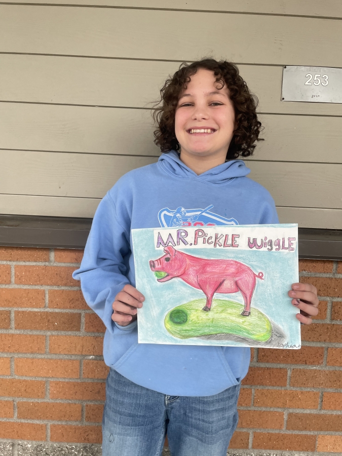 Canyon Creek Middle School sixth-grader Sophia Genova holds a piece of her artwork outside the Washougal middle school, Friday, Feb. 23, 2024.