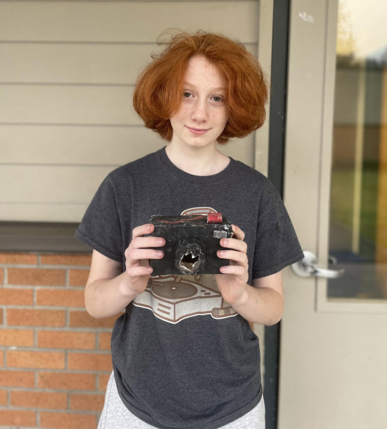 Canyon Creek Middle School sixth-grader Lilly Kogel holds a piece of her artwork outside the Washougal school, Tuesday, Feb. 27, 2024.