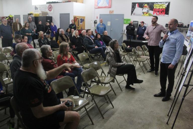 Monty Hill (lfar right) and Adam Goldberg (second from right), architects for Portland-based MacKenzie Architecture, talk about design options for the city of Washougal&rsquo;s new fire station project during an open house on Thursday, Feb.