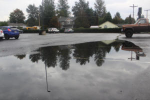Doug Flanagan/Post-Record   Nearby trees are reflected in a puddle covering multiple spaces in Washougal High School's student parking lot on Monday, Oct. 9, 2023 (Contributed photo courtesy of the Lower Columbia Estuary Project)