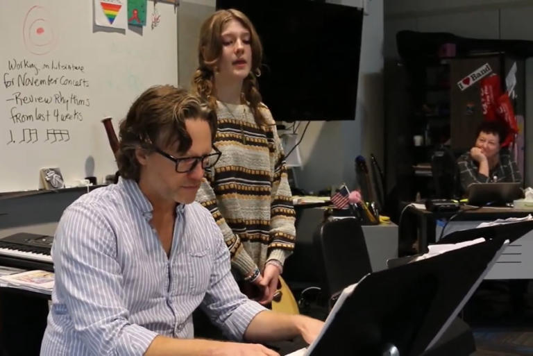 Screenshot by Doug Flanagan/Post-Record 
 Jemtegaard Middle School seventh-grader sings Adele's &quot;Easy On Me,&quot; accompanied by her father Arno Lampmann (left) on piano, while choir teacher Jennifer Hodapp (listens) on Oct. 23, 2023. (Doug Flanagan/Post-Record)