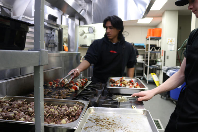 Washougal High School students Xavier Pineda-Gutierrez (left) and Drake Leifsen prepare the kabobs prepare kabobs, which were served from the Shoug Shack food truck on Friday, Feb.