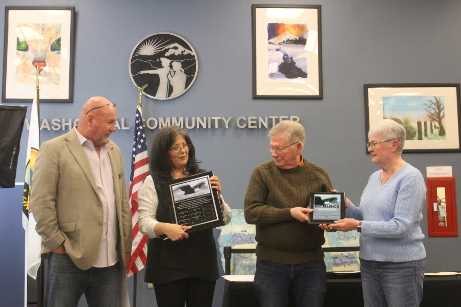 Rose Jewell (second from left), the city of Washougal&rsquo;s community engagement manager, presents plaques to Chuck and Barbara Carpenter (second from right and far right) as the winners of the 2023 Rose M. Jewell Volunteer of the Year award as Mayor David Stuebe looks on during the city of Washougal&rsquo;s Hometown Heroes event, held March 21 at the Washougal Community Center. (Doug Flanagan/Post-Record)