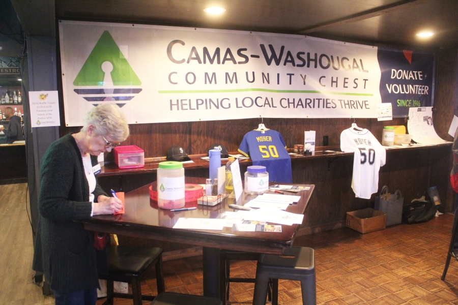 Doug Flanagan/Post-Record 
 Camas-Washougal Community Chest co-treasurer Marianne Reiter organizes raffle tickets during the Camas-Washougal Community Chest's "Pitching In for a Cause" fundraising event, held March 25 at the Washougal Times.