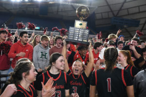 Camas senior Riley Sanz (3) lifts the state championship trophy in front of the Camas student section Saturday, March 2, 2024, after the Papermakers’ 57-41 win against Gonzaga Prep in the 4A WIAA State Basketball championship game at the Tacoma Dome. (Taylor Balkom/The Columbian)