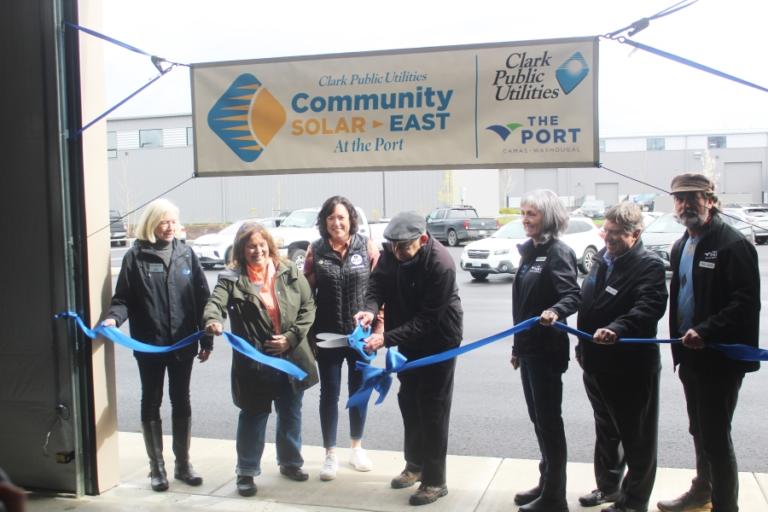 Clark Public Utilities Commissioner Jim Malinowski (center) cuts a ribbon at the Port of Camas-Washougal industrial park, March 27, 2024, as (left to right) CPU commissioners Nancy Van Dyke and Nancy Barnes, Washington state 18th District Rep. Stephanie McClintock, and Port of Camas-Washougal commissioners Cassi Marshall, Larry Keister and John Spencer look on.