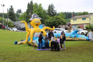 A crowd gathers at an octopus-shaped bouncy ride during the Camtown Youth Festival on Saturday, June 4, 2022. (Kelly Moyer/Post-Record files)