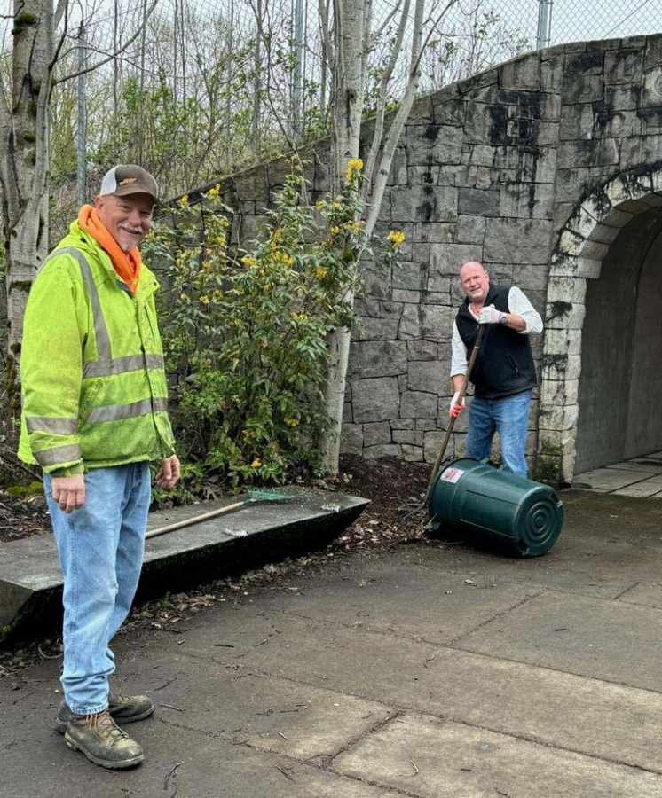 Myron Crumpacker (left),  a city of Washougal public works employee, and Washougal Mayor David Stuebe clean an area next to the pedestrian tunnel near Pendleton Woolen Mills, April 6, 2024, as part of the City&rsquo;s inaugural Parks Pals event. (Contributed photos courtesy of the city of Washougal)