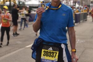 Camas resident Gary Abrahamsen holds a  medal that he received for finishing the Boston Marathon on April 15, 2024. (Photo courtesy of Gary Abrahamsen)