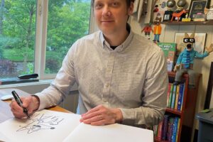 Award-winning cartoonist Aron Nels Steinke, a 1999 Camas High School graduate, draws in his Portland home on April 30, 2024.  (Photo by Marlen Steinke, courtesy of Aron Nels Steinke)
