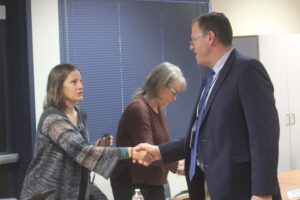 Aaron Hansen (right) shakes hands with Washougal School Board member Ida Royer during an April 30, 2024 school board meeting, after the Board announced Hansen will act as interim superintendent, beginning July 2024, while the district seeks a permanent replacement to outgoing Washougal School District Superintendent Mary Templeton. (Doug Flanagan/Post-Record) 